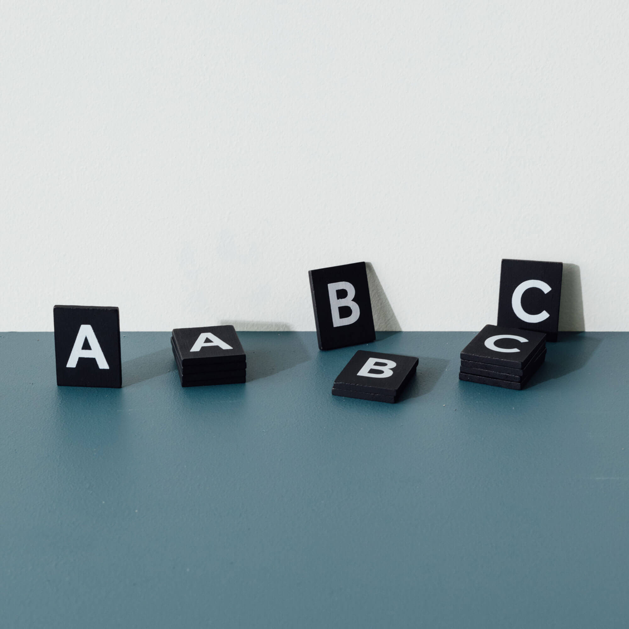 wooden letter board black tiled letters close up