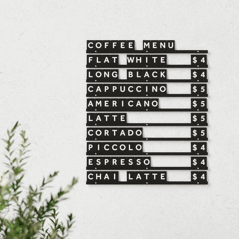 small wooden letter board menu display in black rails black letter tiles colourway used in a cafe