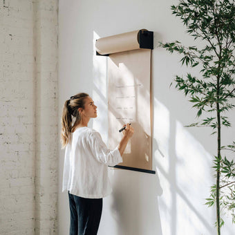 girl writing on the studio roller paper