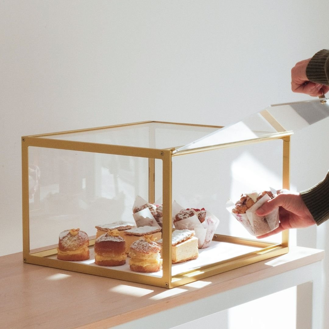 Small brass bakery display case door lifted