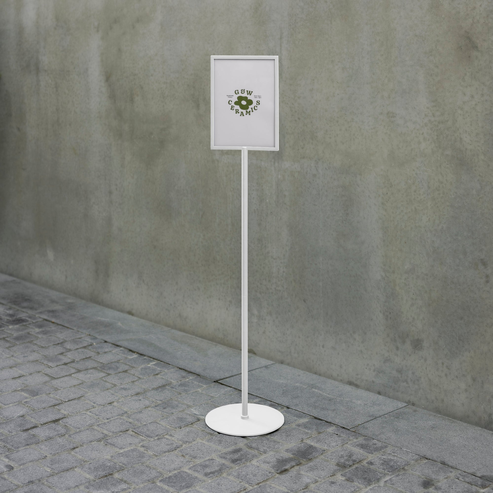 white tall standing sign holder outside on concrete
