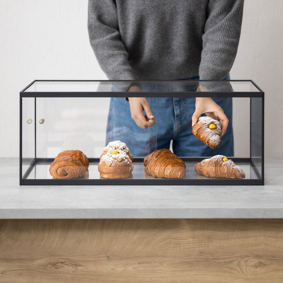 Bakery display case with croissants on wooden counter, scratch-free acrylic panels