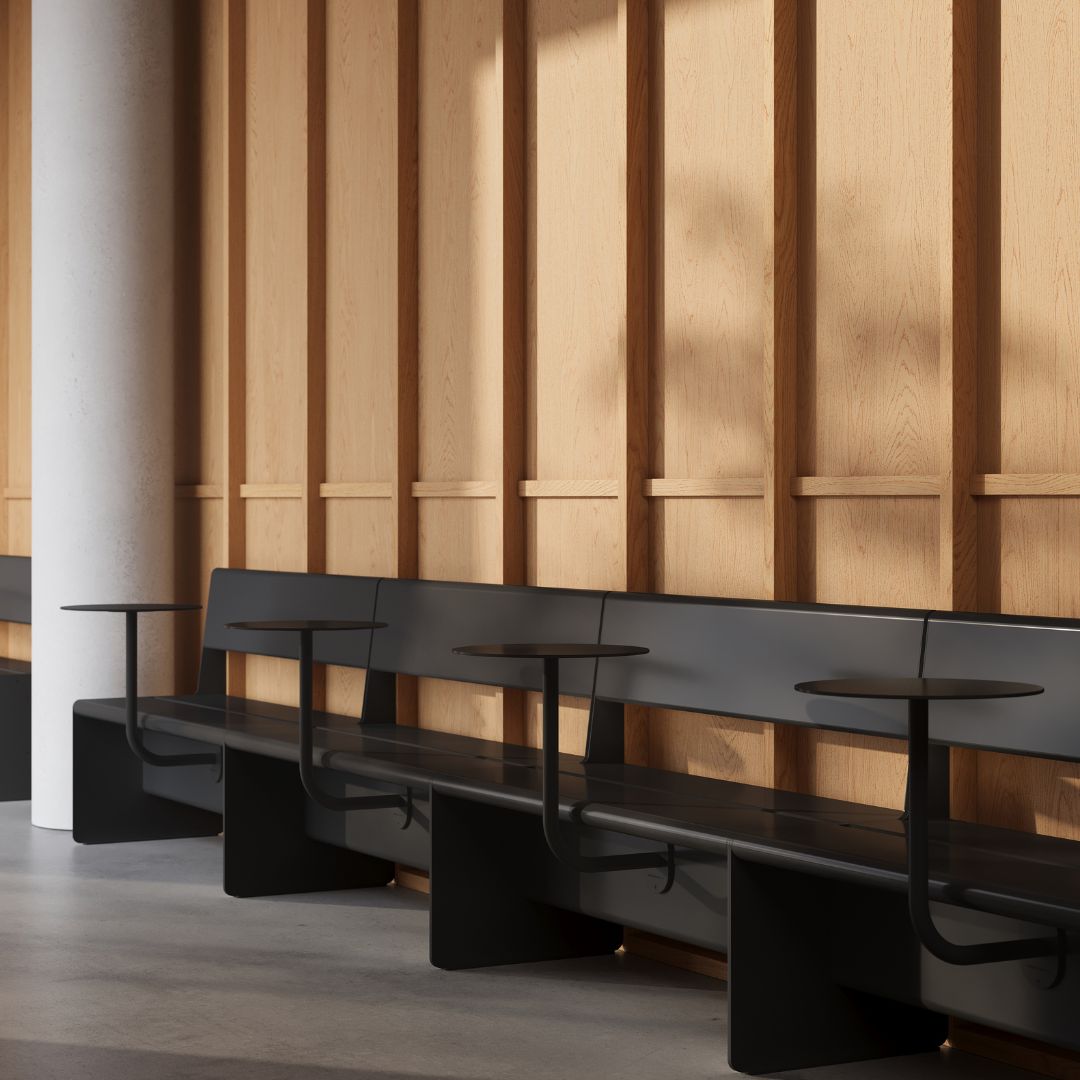 black booth seats sitting alongside each other with wall mounted cafe tables attached