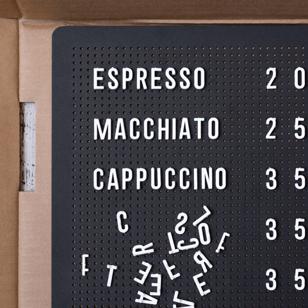 white peg letters in a black metal menu display