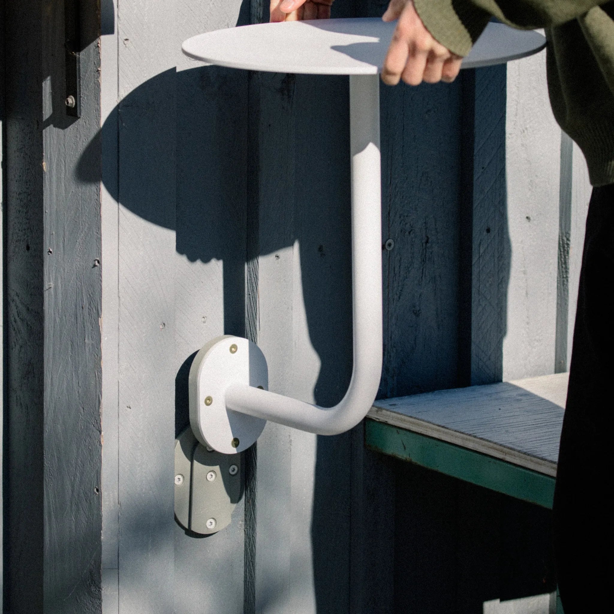 photo of a person removing table from a wall mounted table bracket